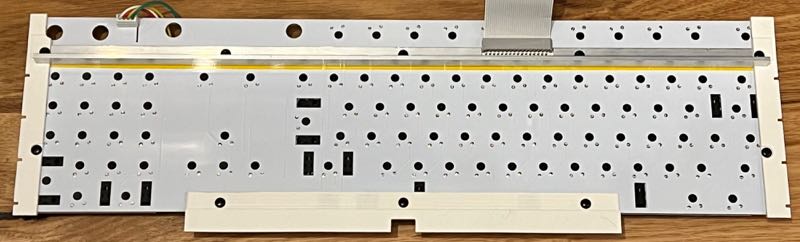 Rear of keyboard showing aluminium extrusion, mounting pieces and rivets